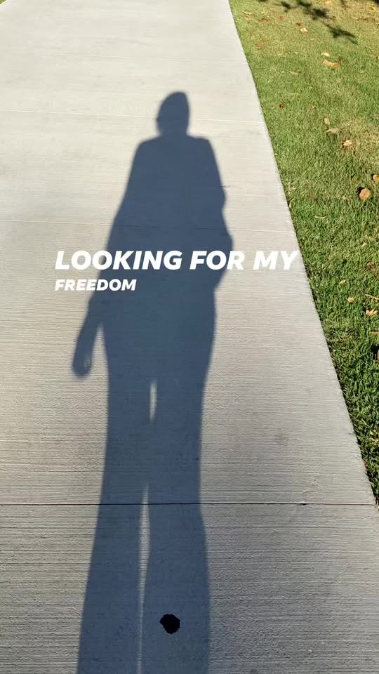someone's long shadow is being cast on a sidewalk