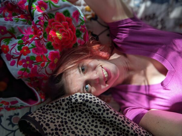 selfie of a person laying between brightly patterned bags