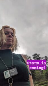selfie of a person with dark clouds behind them and the text Storm is coming!