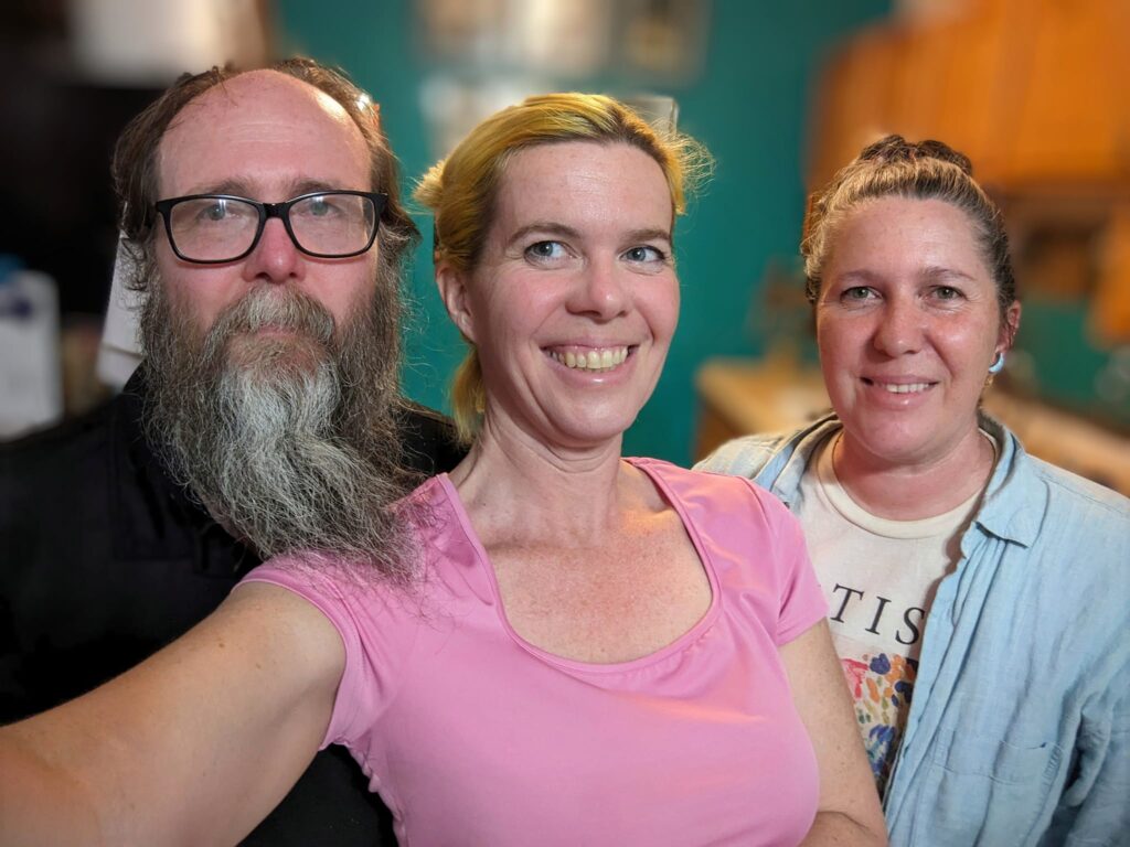 selfie of three people standing in a kitchen