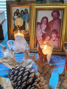 a table is covered with knickknacks and photos