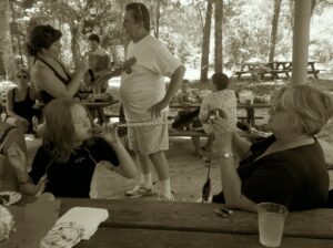 several people are standing around a picnic pavilion in a park