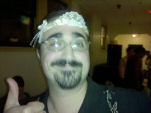 very blurry shot of someone doing thumbs up and wearing a lace headband