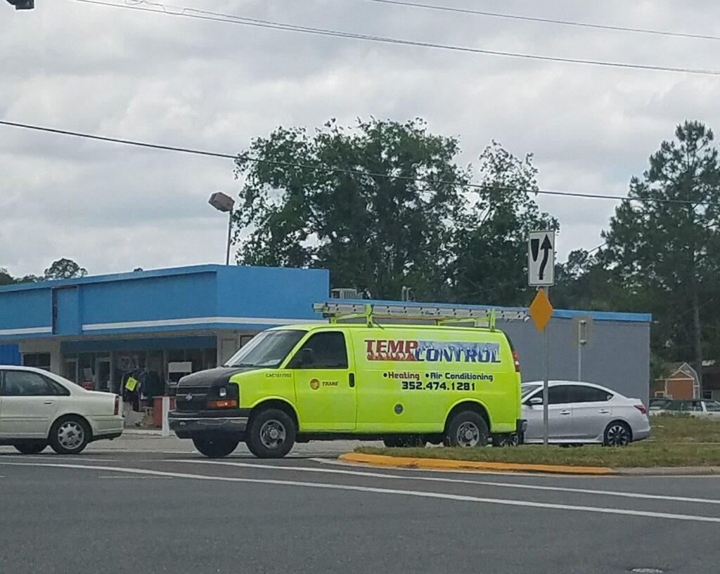 a blindingly brilliant yellow work van appears to be for an air condition repair company