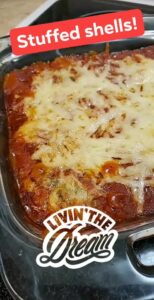 a casserole dish has something red in it covered in cheese