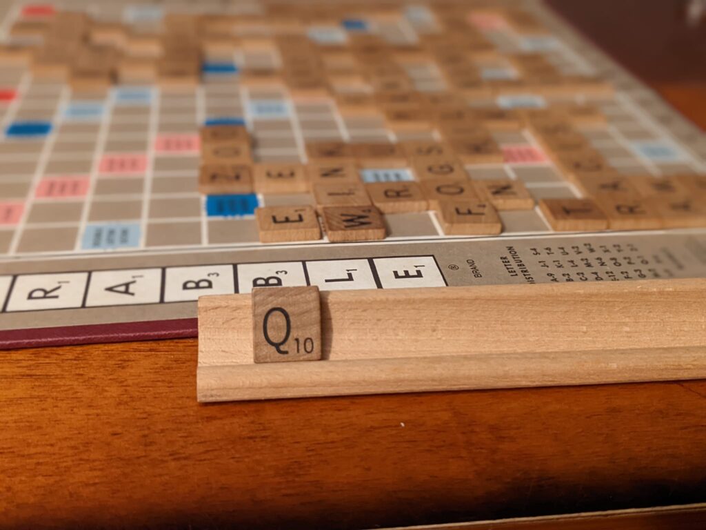 a scrabble board is mostly played and the last tile to be played is a Q