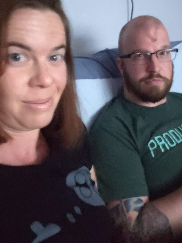 selfie of two people sitting on a couch