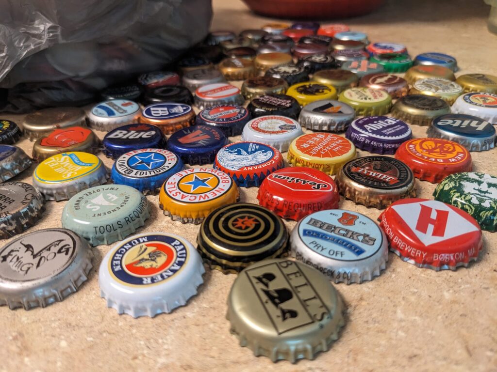 a lot of colorful bottlecaps are spread out on a table