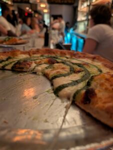 close up of half a pizza in a restaurant of some kind