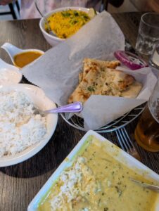 a dinner table with several dishes of what looks like Indian food
