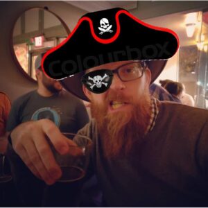 a person holding a drink and making a face with a long beard has a pirate hat and eye patch obviously photoshopped onto him