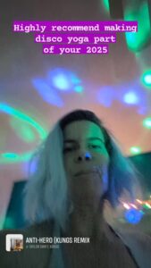 a blurry selfie of a person surrounded by colorful lights and the text ' Highly recommend making disco yoga part of your 2025'