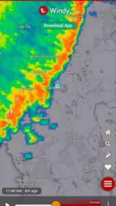 screenshot of a weather map with an arch of reds and yellows indicating a line of storms heading from west to east across the region